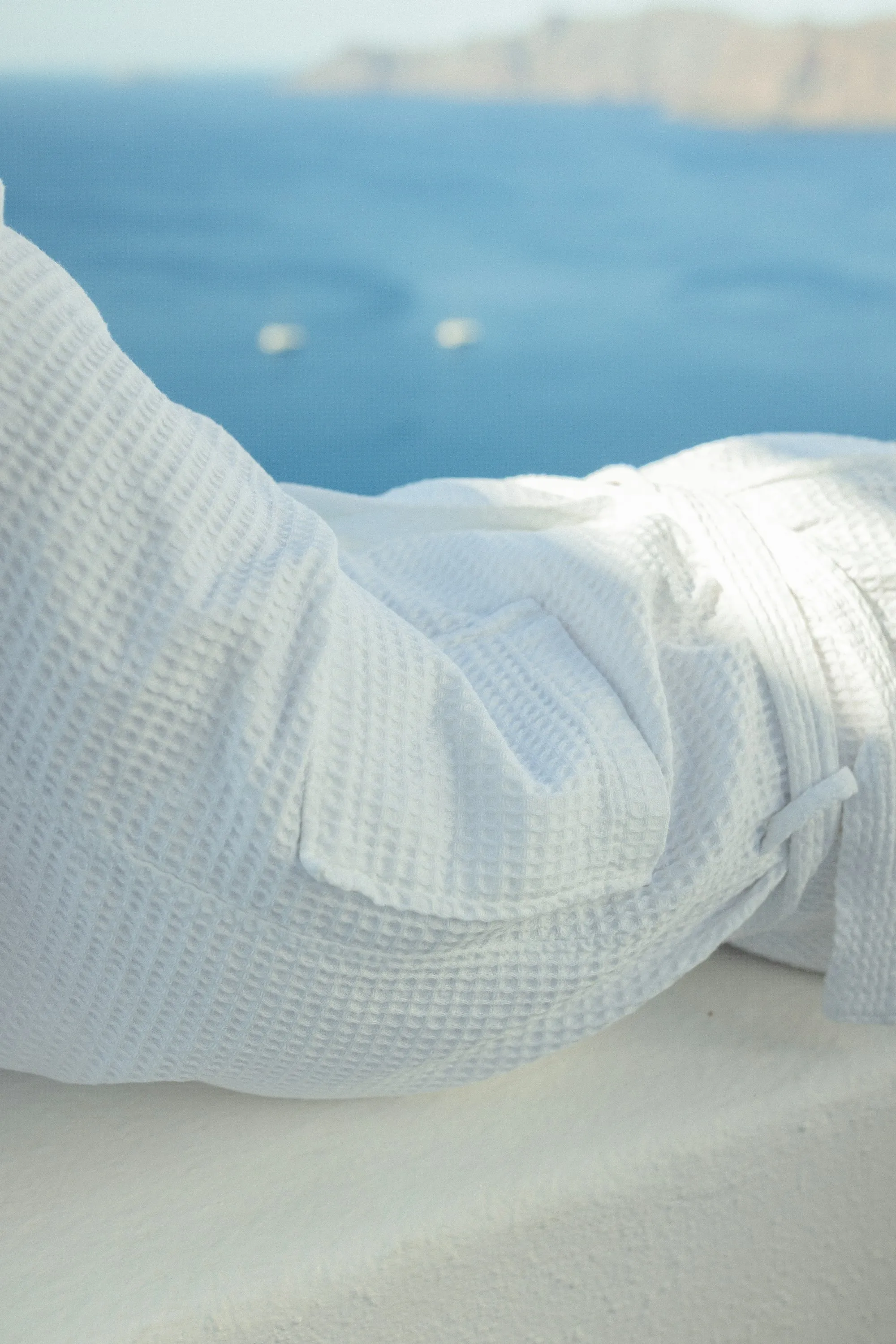 Soft white towel draped by a window